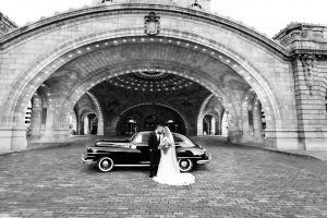 Wedding picture with bride and groom in front of classic car at the Pennsylvanian in Pittsburgh, PA Araujo Photography