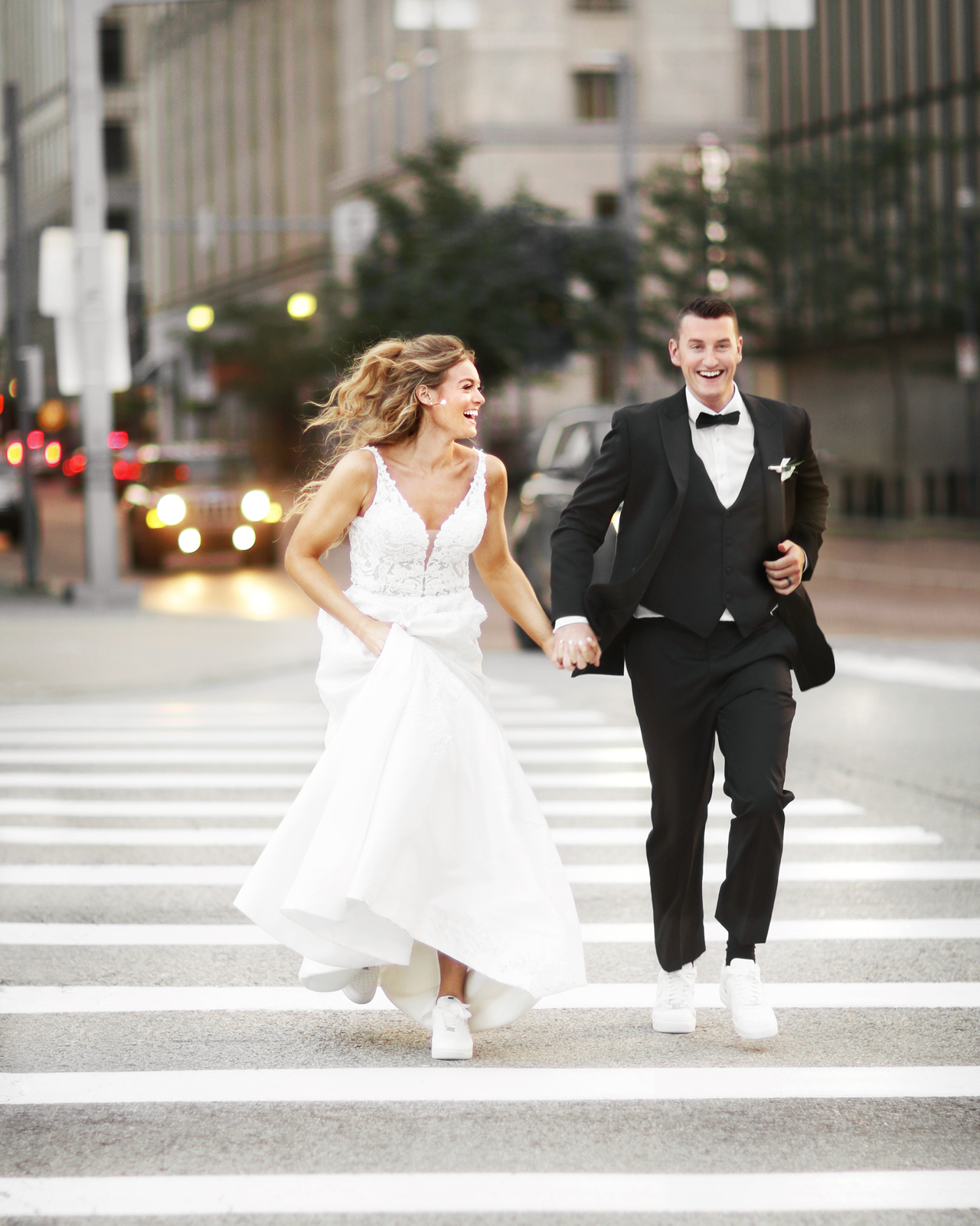 cute picture of bride and groom running across a street in Pittsburgh, PA