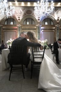 bride and groom kissing at the head table at a wedding reception in Pittsburgh, PA
